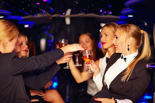 Reason why people love limos - a group of friends having a party in the limousine.