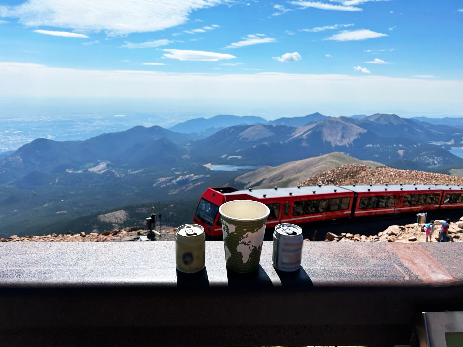 Red train climbing Pikes Peak mountain.