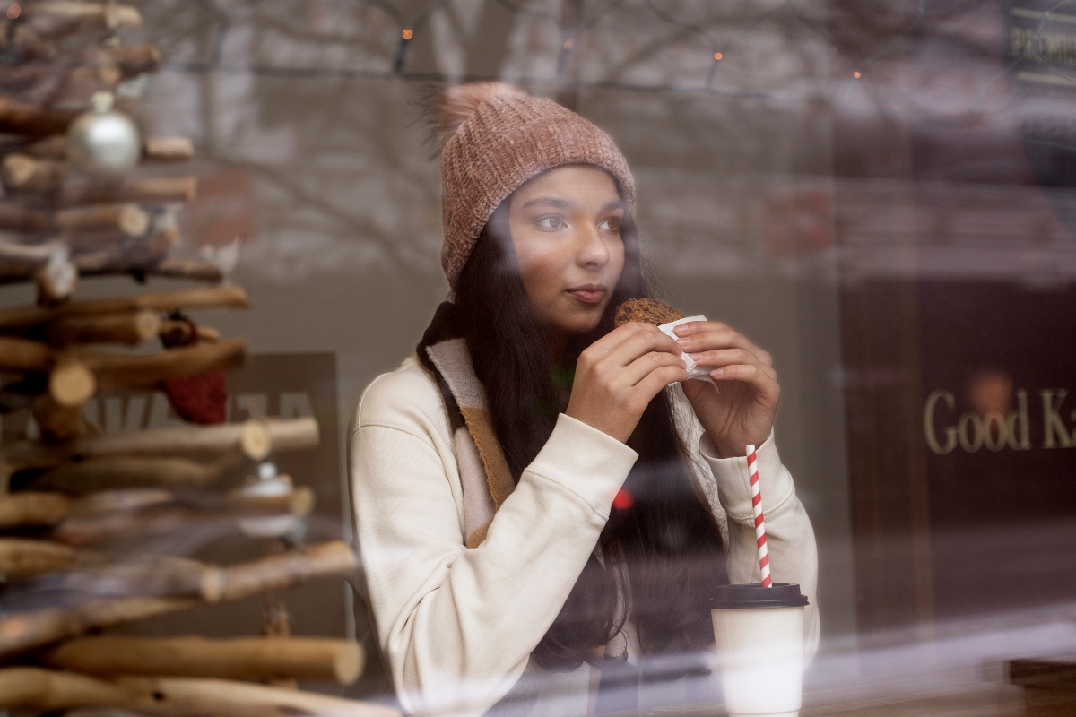 A young woman enjoying a cozy cafe. 